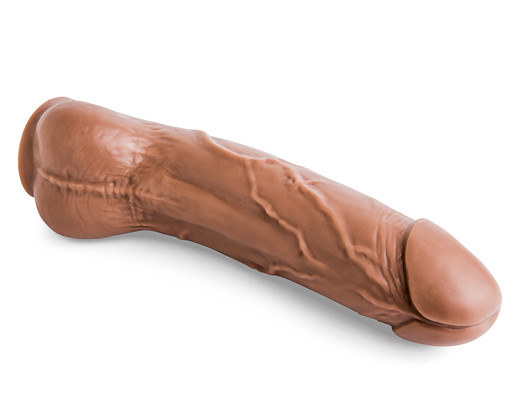 A brown rubber dildo, sizable and prominent, placed on a plain white background.