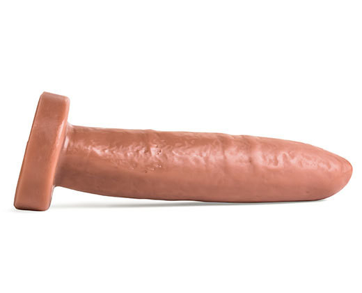 A white background showcases a large rubber cock