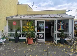 A vibrant yellow building with a sign that reads "sunshine".